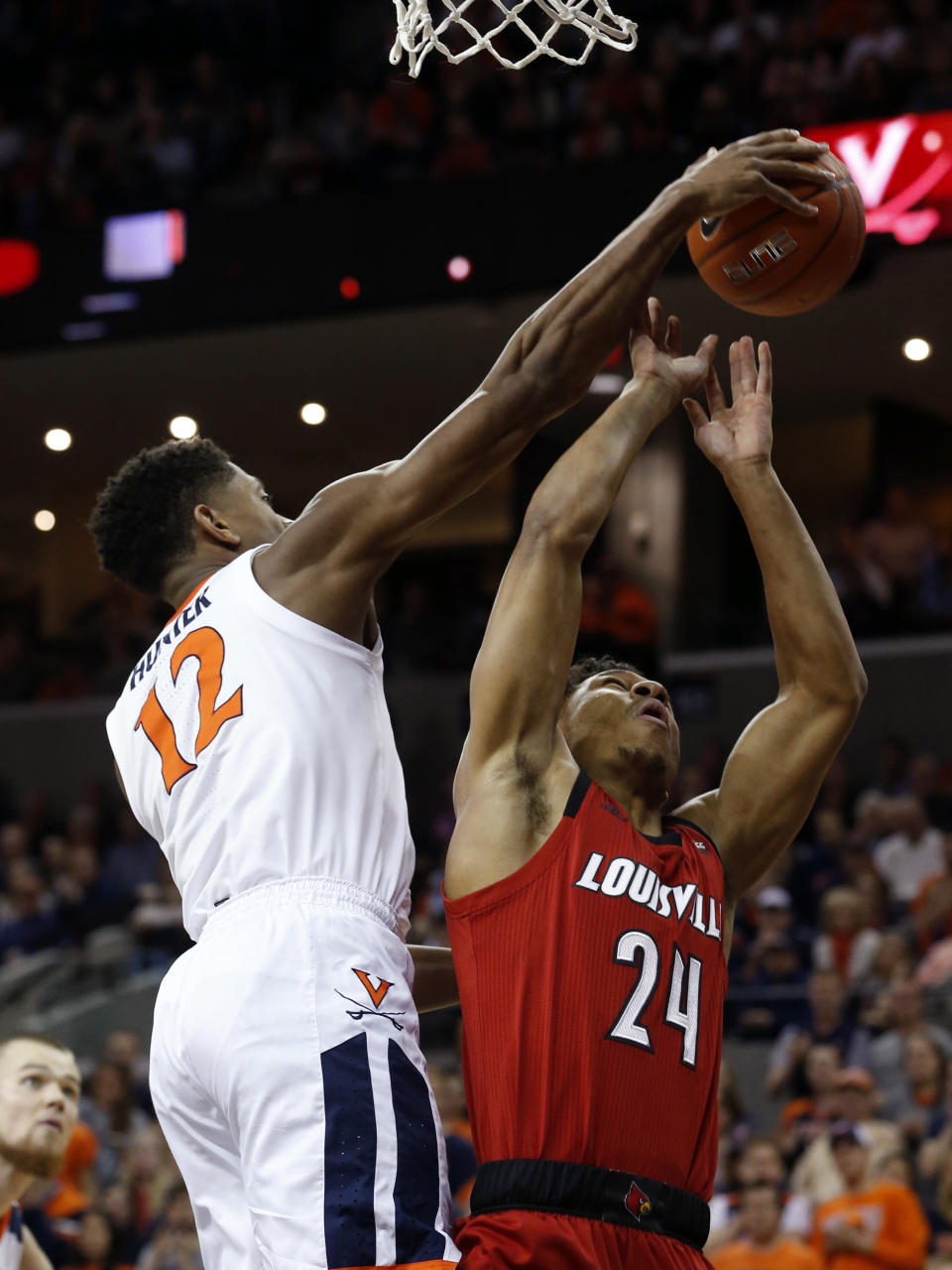 Virginia guard De'Andre Hunter (12) blocks the shot of Louisville forward Dwayne Sutton (24) during the first half of an NCAA college basketball game in Charlottesville, Va., Saturday, March 9, 2019. (AP Photo/Steve Helber)