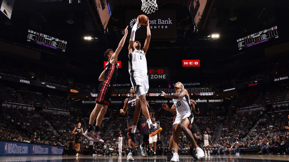 Wembanyama dunks the ball during the game against the Heat. - Garrett Ellwood/NBAE/Getty Images