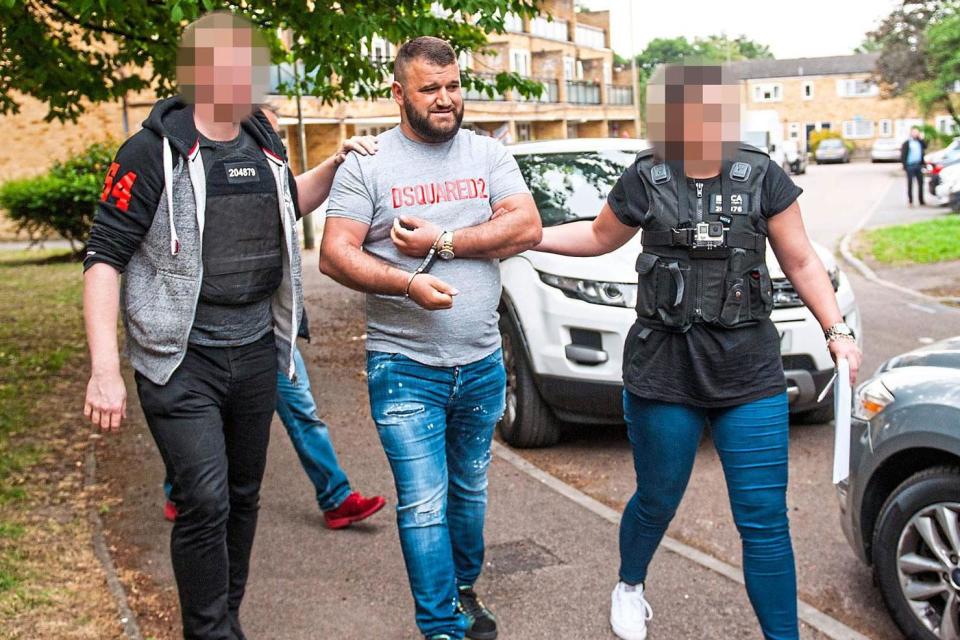 Police today swooped on a gang suspected of smuggling hundreds of migrants hidden in refrigerated trucks into Britain.The suspected ringleader of the Albanian gang was arrested in a dawn raid at a council flat in Penge, south London, as part of a Europe-wide investigation.The 31-year-old was led from his home in handcuffs and joked “I remember you very well” to an undercover National Crime Agency officer who had kept him under surveillance before today’s arrest. His wife and two young children were left stunned as officers grabbed him from the one-bedroom flat. As he was bundled into a car in handcuffs the man said to the Standard: “Write me up good, did you get good shots [photographs]?” Ten other gang members have already been arrested in connection with the investigation in Belgium, France and Spain. The gang allegedly used corrupt truck drivers to pick up migrants in Belgium and get them to the UK through ports and the Channel Tunnel. They are likely to have been involved with hundreds of migrants attempting to reach the UK, the NCA said. The suspect was held on a European Arrest Warrant at the request of Belgian Federal Police who are overseeing the inquiry. A Belgian officer, who saw today’s raid, said: “There is so much money in smuggling that others will be queuing up to take his place. They will take the risk knowing an arrest can happen. It’s not that victims are beaten or treated badly but the danger of putting women and children in refrigerated trucks is enormous. The air supply can be cut off.”The gang allegedly smuggled in Albanian nationals, who paid extortionate rates to stay in hotels in Belgium before coming into the UK.Martin Matthews, deputy senior investigations officer at the NCA, said: “The people involved are still being put at huge risk. This is higher end than people being trafficked for sex or slavery, this is people paying money to get into the UK. Often those people being smuggled in are here to engage in criminal activity themselves. Organised migration crime has a massive impact on the UK.“By working with our partners in Belgium arresting people actively facilitating the arrival of migrants it will have a massive impact on their operation.”