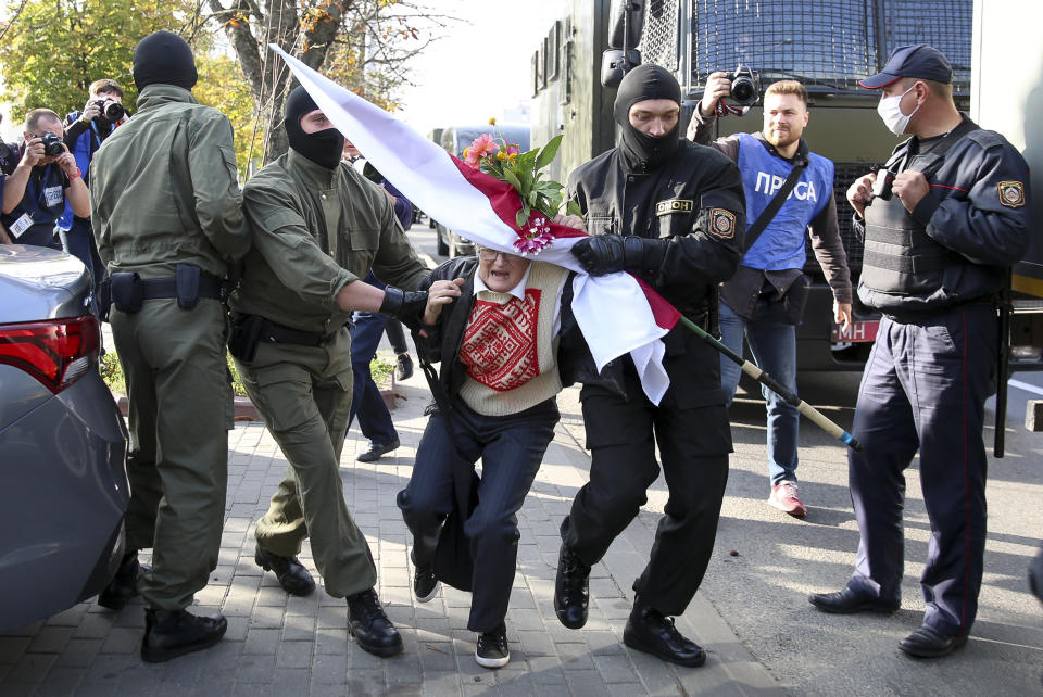 Police officers detain Nina Bahinskaya, 73, during an opposition rally to protest the official presidential election results in Minsk, Belarus, Saturday, Sept. 19, 2020. Daily protests calling for the authoritarian president's resignation are now in their second month and opposition determination appears strong despite the detention of protest leaders. (AP Photo/TUT.by)