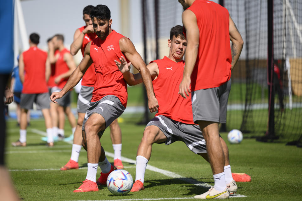 Switzerland's defender Eray Coemert, left, and Switzerland's midfielder Ardon Jashari, right, attend a closed training session of Swiss national soccer team on the eve of the FIFA World Cup Qatar 2022 soccer match against Cameroon at the University of Doha for Science and Technology training facilities, in Doha, Qatar, Wednesday, Nov. 23, 2022. The Swiss national soccer team will play in group G of the FIFA World Cup Qatar 2022. (Laurent Gillieron/Keystone via AP)