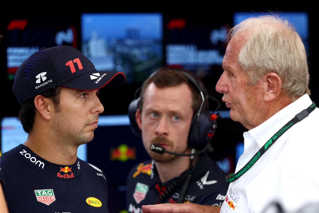 SINGAPORE, SINGAPORE - SEPTEMBER 15: Sergio Perez of Mexico and Oracle Red Bull Racing talks with Red Bull Racing Team Consultant Dr Helmut Marko in the garage during practice ahead of the F1 Grand Prix of Singapore at Marina Bay Street Circuit on September 15, 2023 in Singapore, Singapore. (Photo by Clive Rose/Getty Images)