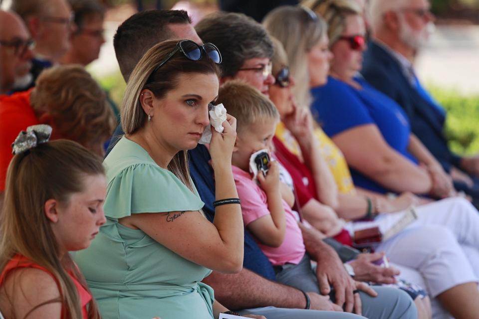 Megan Gwynes, daughter-in-law of Deputy Jack Gwynes, wipes a tear during a memorial service Wednesday at the Nassau County Sheriff's Office that remembered him and Deputy Joshua Moyers. Both died in the line of duty last year.