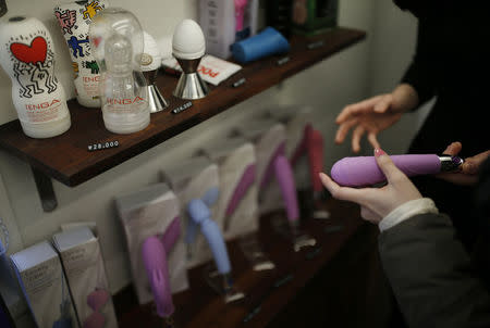Kwak Eura explains a product to a customer at her sex toy shop in Seoul, South Korea, December 16, 2015. REUTERS/Kim Hong-Ji
