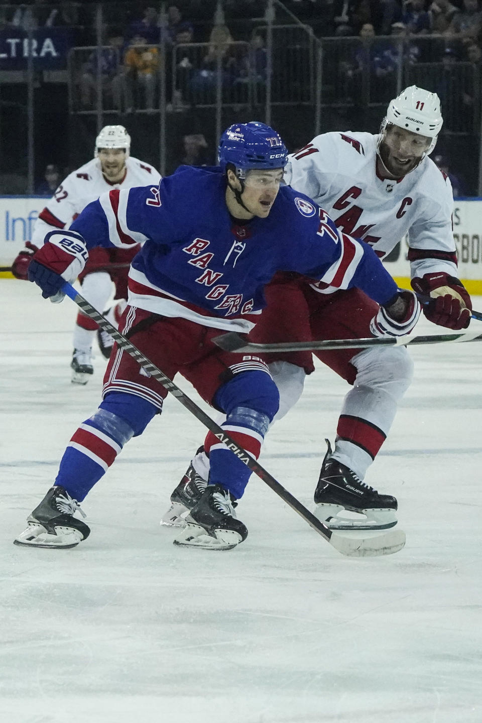 New York Rangers center Frank Vatrano (77) and Carolina Hurricanes center Jordan Staal (11) goes for a loose puck during first period of NHL hockey game, Tuesday, April 12, 2022, in New York. (AP Photo/Bebeto Matthews)