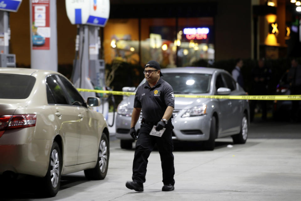 Garden Grove police work the scene of a stabbing in Garden Grove, Calif., Wednesday, Aug. 7, 2019. A man killed multiple people and wounded others in a string of robberies and stabbings in California's Orange County before he was arrested, police said Wednesday. (AP Photo/Alex Gallardo)
