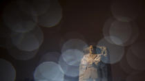 In a long exposure photo, lights from a snowplow illuminate sleet at the Martin Luther King Jr. Memorial in Washington, Sunday, Jan. 16, 2022. Ceremonies scheduled for the site on Monday, to mark the Martin Luther King Jr. national holiday, have been canceled because of the weather. (AP Photo/Carolyn Kaster)