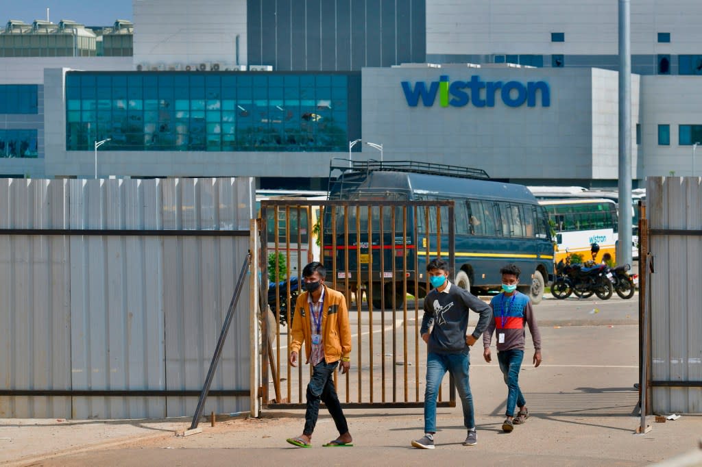 People exit from the gate of Wistron, a Taiwanese-run iPhone factory.