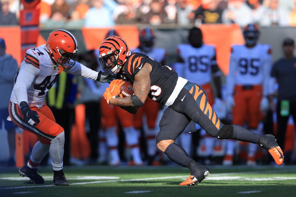 Cincinnati Bengals' Joe Mixon (28) is tackled by Cleveland Browns' Sione Takitaki (44) during the second half of an NFL football game, Sunday, Nov. 7, 2021, in Cincinnati. (AP Photo/Aaron Doster)