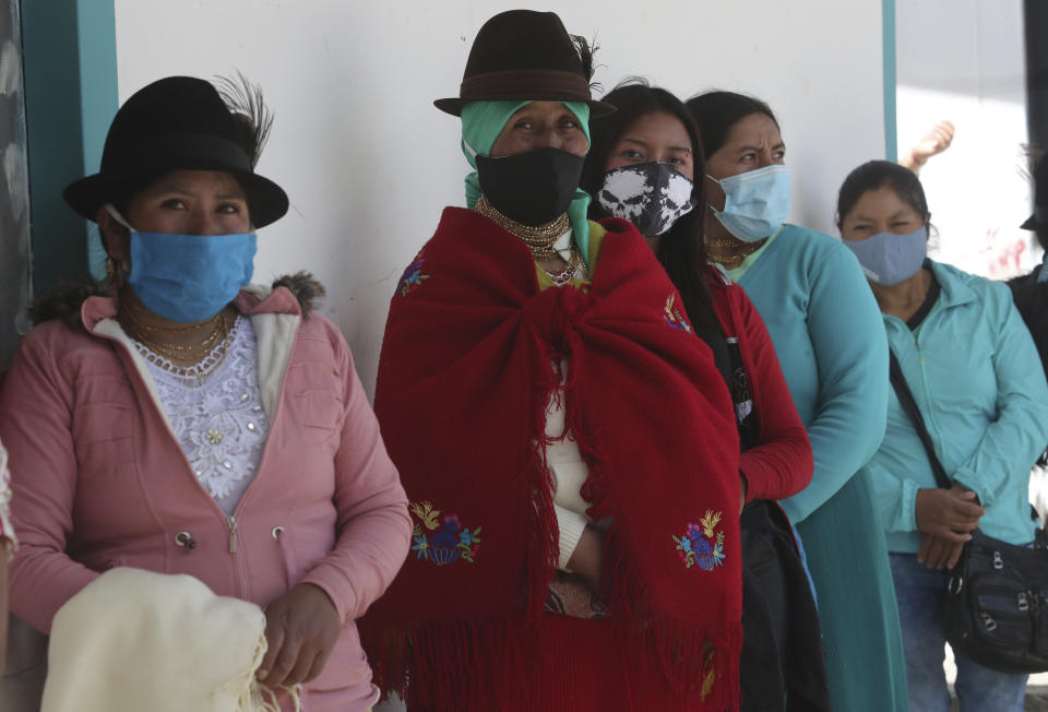 Women line up to cast their ballots in Cangahua, Ecuador, Sunday, Feb. 7, 2021. Ecuadoreans went to the polls in first-round presidential and legislative elections. (AP Photo/Dolores Ochoa)