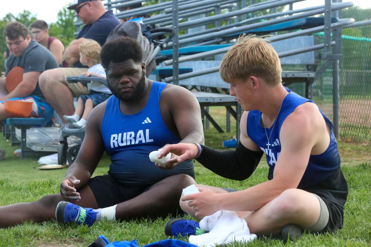 Washburn Rural's Josh Sulzen-Watson and Jamond Lane share chalk with each other during the Joe Schrag City Meet on Friday, May 3.