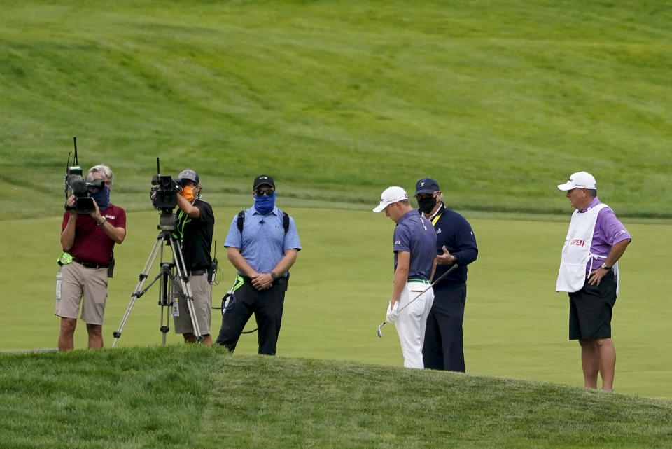 Justin Thomas, of the United States, talks to an official on the 17th fairway during the first round of the US Open Golf Championship, Thursday, Sept. 17, 2020, in Mamaroneck, N.Y. (AP Photo/Charles Krupa)