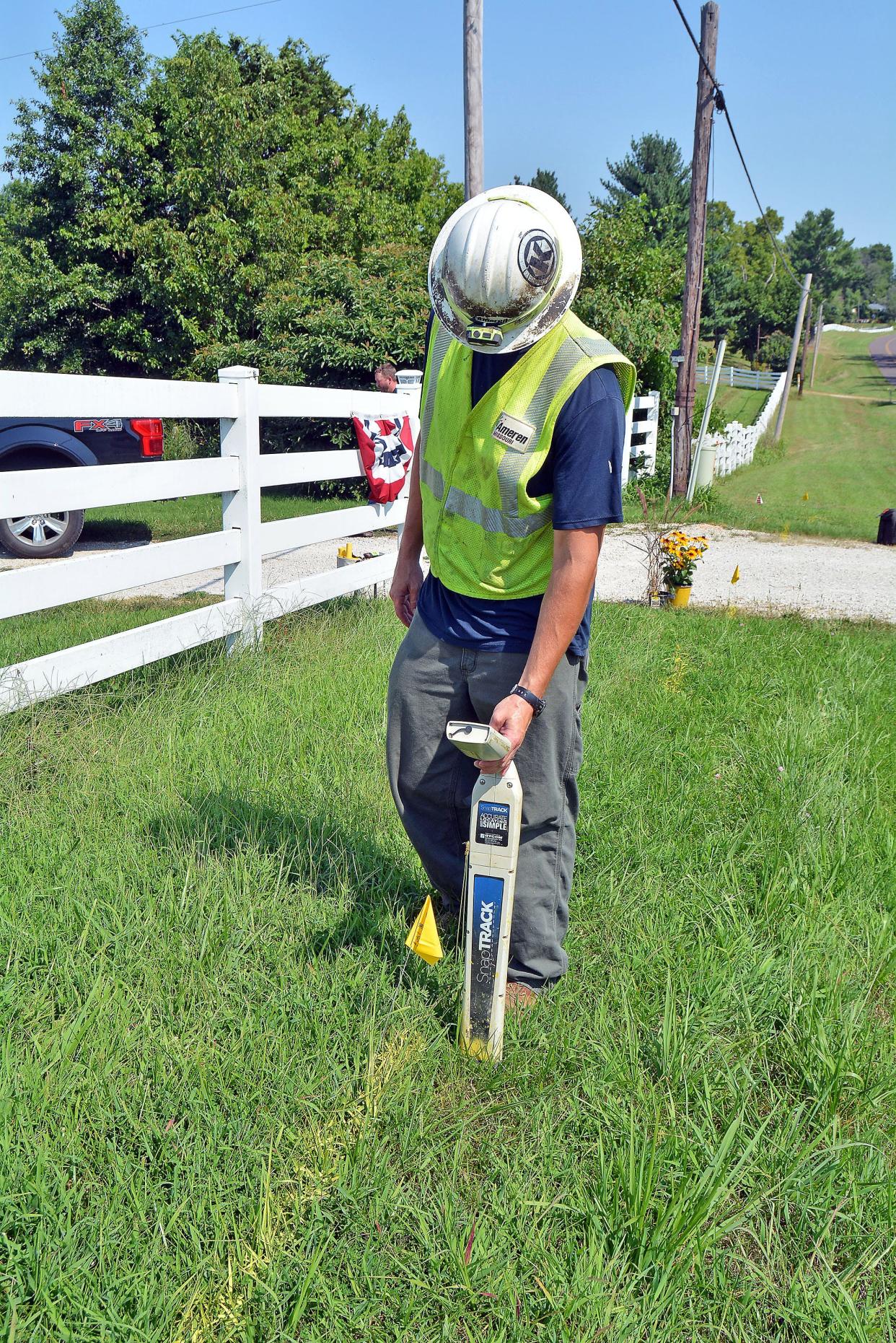 Ameren Gas Service Worker Kyle Werdehausen demonstrates Monday how he uses a locator to mark where a line is buried at a property in Hartsburg. Locator wires run adjacent to gas lines.