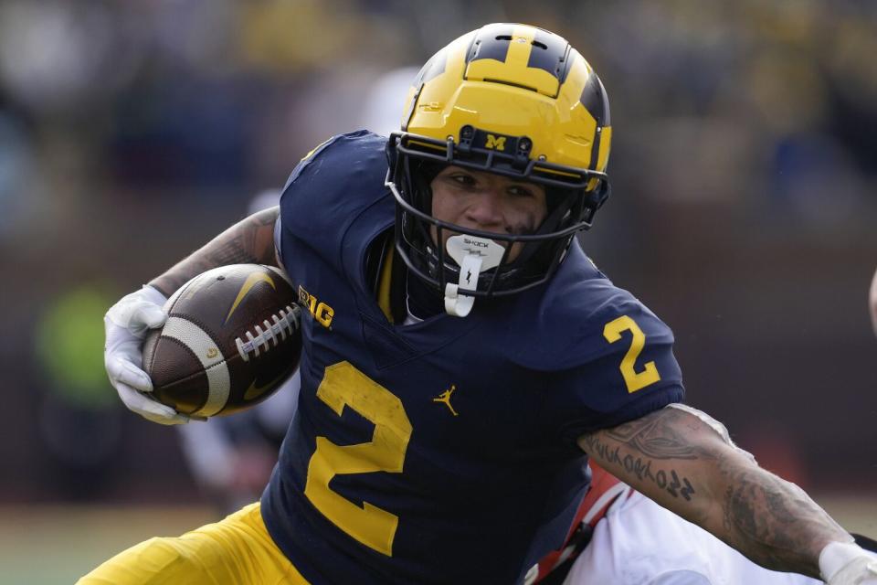 Michigan running back Blake Corum carries the ball against Illinois