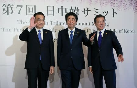 Chinese Premier Li Keqiang, Japanese Prime Minister Shinzo Abe and South Korean President Moon Jae-in pose for photographers prior to their summit in Tokyo, Wednesday, May 9, 2018. Eugene Hoshiko/Pool via Reuters