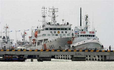 China's largest patrol vessel in the South China Sea "Haixun 31" (C) is seen at a port before leaving for search and rescue operations for the missing Malaysia Airlines flight MH370, in Sanya, Hainan province. REUTERS/Stringer