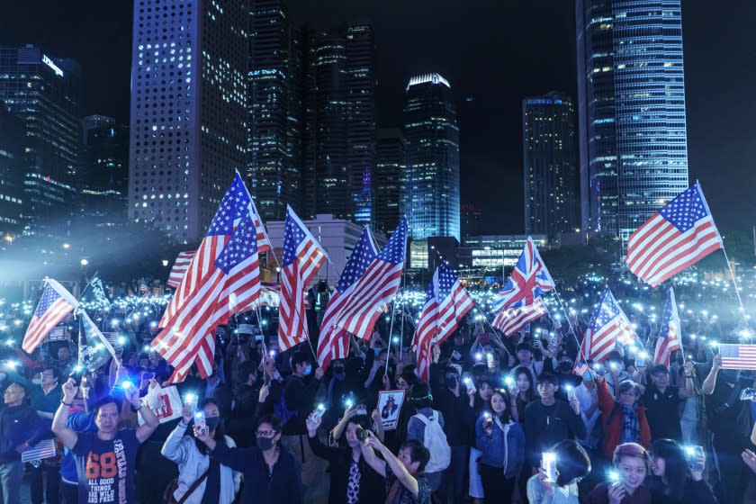 HONG KONG, CHINA -- THURSDAY, NOVEMBER 28, 2019: Singing the "star spangle banner," waving American flags and waving banners bearing the protest slogan: "Liberate Hong Kong, revolution of our times," Pro-democracy demonstrators gather for a Thanksgiving rally to commemorate President Trump signing the Hong Kong Human Rights and Democracy Act into law, at the Central district of Hong Kong, on Nov. 28, 2019. The Hong Kong Human Rights and Democracy Act requires an annual review of whether Hong Kong retains enough autonomy to justify its special trade status with the U.S. The semi-autonomous Chinese territory has separate legal and economic systems as a result of its history as a British colony.(Marcus Yam / Los Angeles Times)
