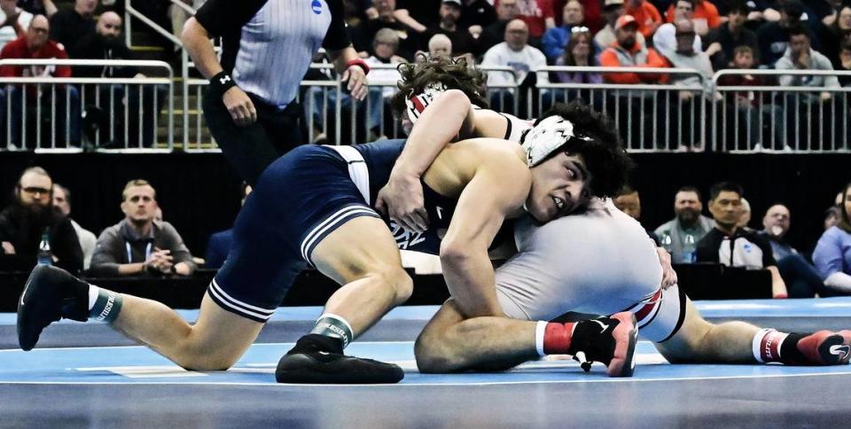 Penn State’s Beau Bartlett, left, wrestles against Ohio State’s Jesse Mendez during the 141-pound NCAA championship Saturday night at the T-Mobile Center in Kansas City, Mo. Mendez won 4-1 to give Bartlett his second loss of the season.