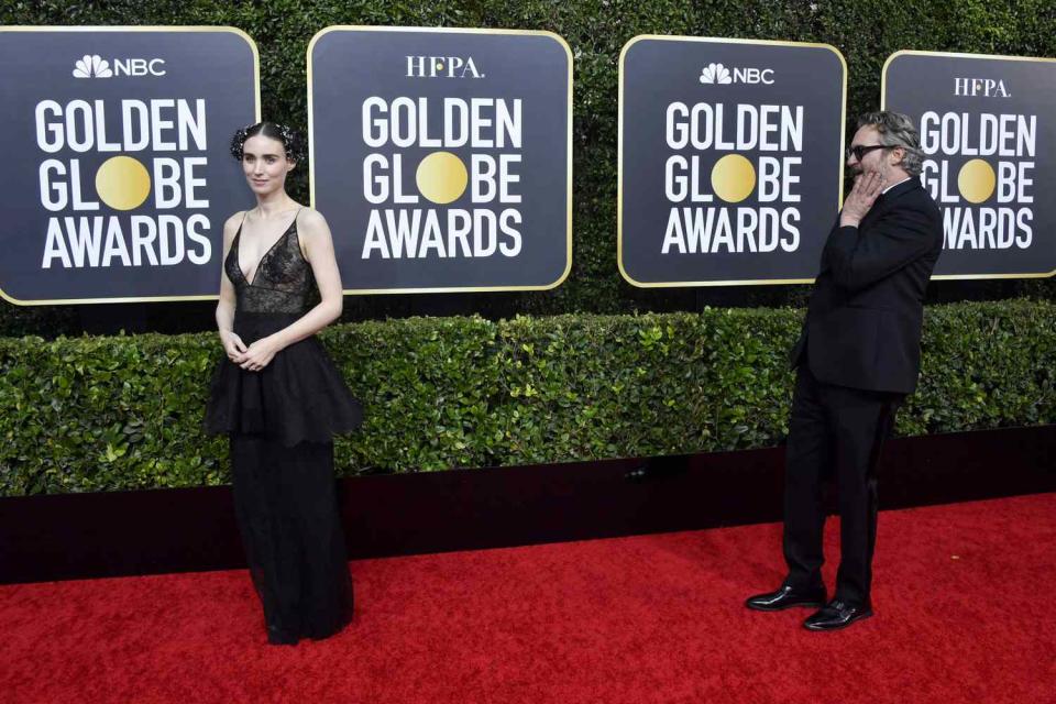 January 5, 2020: Joaquin Phoenix smiles at Rooney Mara on the Golden Globes red carpet