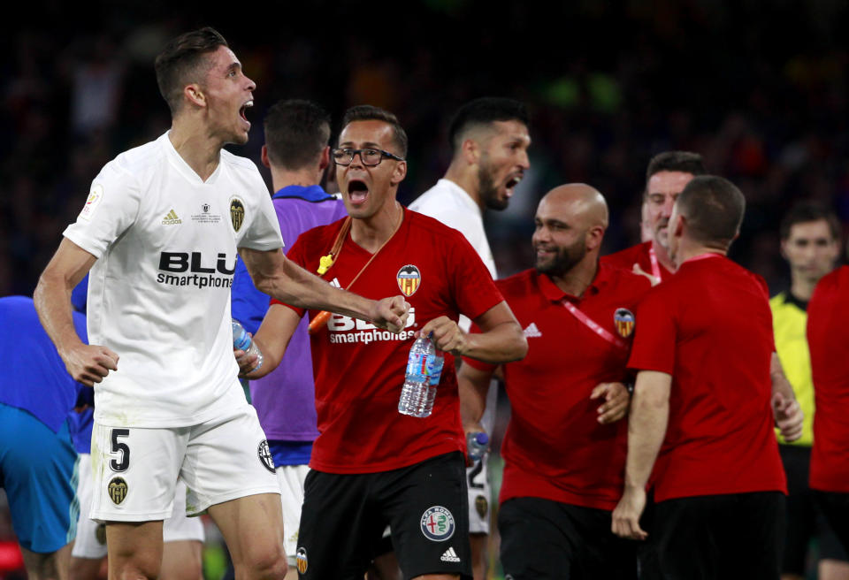 Valencia defender Gabriel Paulista, left, reacts as he celebrates his team's second goal during the Copa del Rey soccer match final between Valencia CF and FC Barcelona at the Benito Villamarin stadium in Seville, Spain, Saturday. 25, 2019. (AP Photo/Miguel Morenatti)