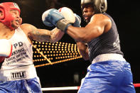 <p>Emmanuel Etienne, left, lands a punch off Jamaal Spence in the ring during the NYPD Boxing Championships at the Theater at Madison Square Garden on June 8, 2017. (Photo: Gordon Donovan/Yahoo News) </p>