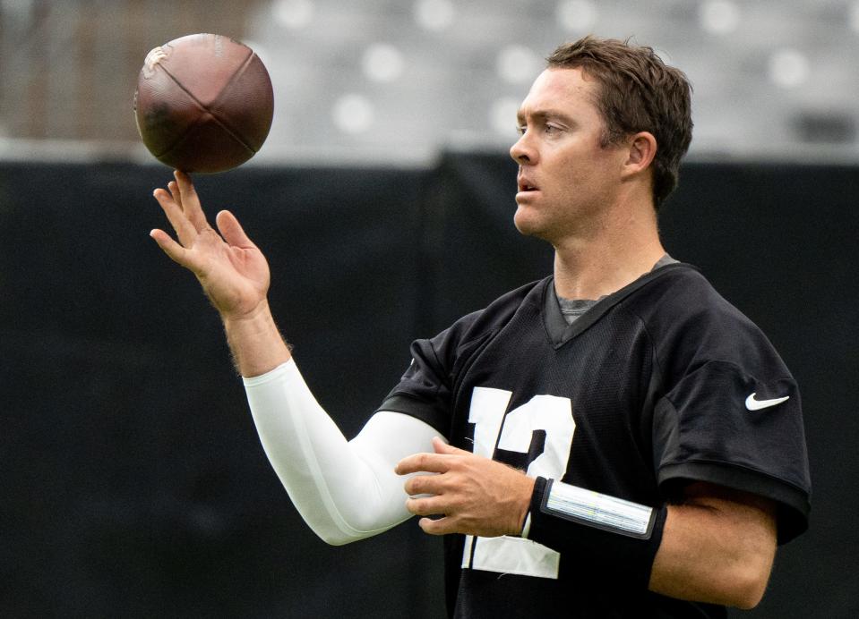 Colt McCoy spins a football during Arizona Cardinals training camp in Glendale, Ariz., on July 31. The Cardinals surprisingly released him in August, and McCoy, 37, is trying to decide what's next for him, including a possible return to the NFL or a shift to broadcasting or coaching.