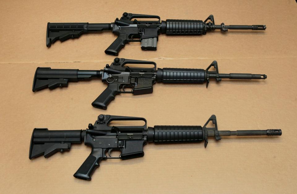 Three variations of the AR-15 assault rifle are displayed at the California Department of Justice in Sacramento, Calif., on Aug. 15, 2012.