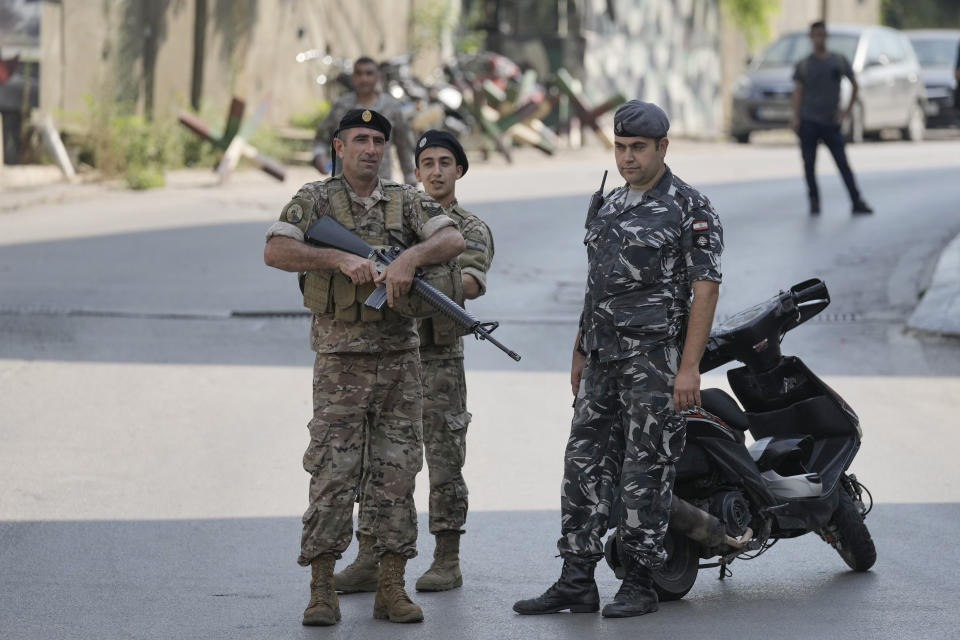 Lebanese security stand guard on a road that leads to the U.S. Embassy in Aukar, a northern suburb of Beirut, Lebanon, Wednesday, June 5, 2024. A gunman was captured by Lebanese soldiers after attempting to attack the U.S. Embassy near Beirut on Wednesday, the military said. (AP Photo/Bilal Hussein)