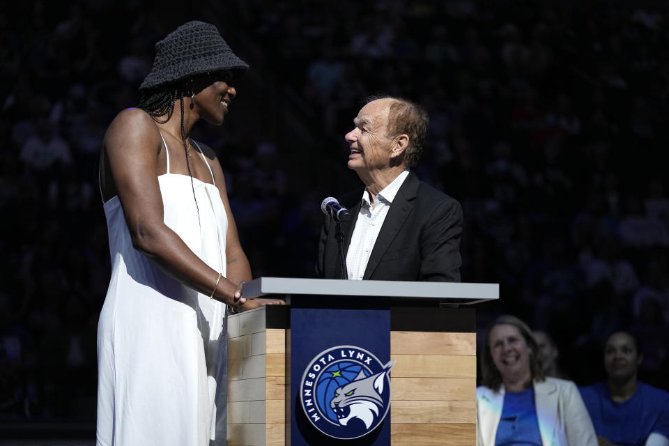 Minnesota Lynx owner Glen Taylor, right, speaks to former Lynx player Sylvia Fowles as her jersey number is retired following a WNBA basketball game between the Minnesota Lynx and Los Angeles Sparks, Sunday, June 11, 2023, in Minneapolis. (AP Photo/Abbie Parr)