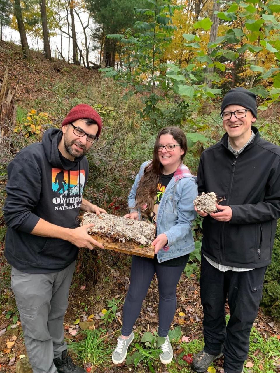 Filmmaker Seth Breedlove, left, and crew members Heather Moser and Mark Matzke stand with what Breedlove says is the cast of an unidentified foot print he collected while working on "The Bigfoot Project" film in the rural Minerva area.