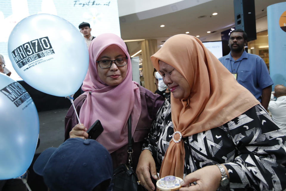 A family member of passengers on board of the missing Malaysia Airlines Flight 370 cries during the tenth annual remembrance event at a shopping mall, in Subang Jaya, on the outskirts of Kuala Lumpur, Malaysia, Sunday, March 3, 2024. Ten years ago, a Malaysia Airlines Flight 370, had disappeared March 8, 2014 while en route from Kuala Lumpur to Beijing with over 200 people on board. (AP Photo/FL Wong)