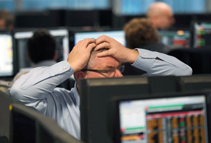 FILE PHOTO: Traders at BGC Partners look at screens after Donald Trump won the U.S. Presidential election, in London