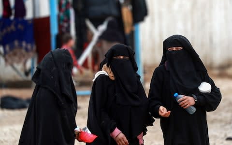 Syrian displaced women walk around the Internallly Displaced Persons (IDP) camp of al-Hol in al-Hasakkah governorate in northeastern Syria  - Credit: AFP