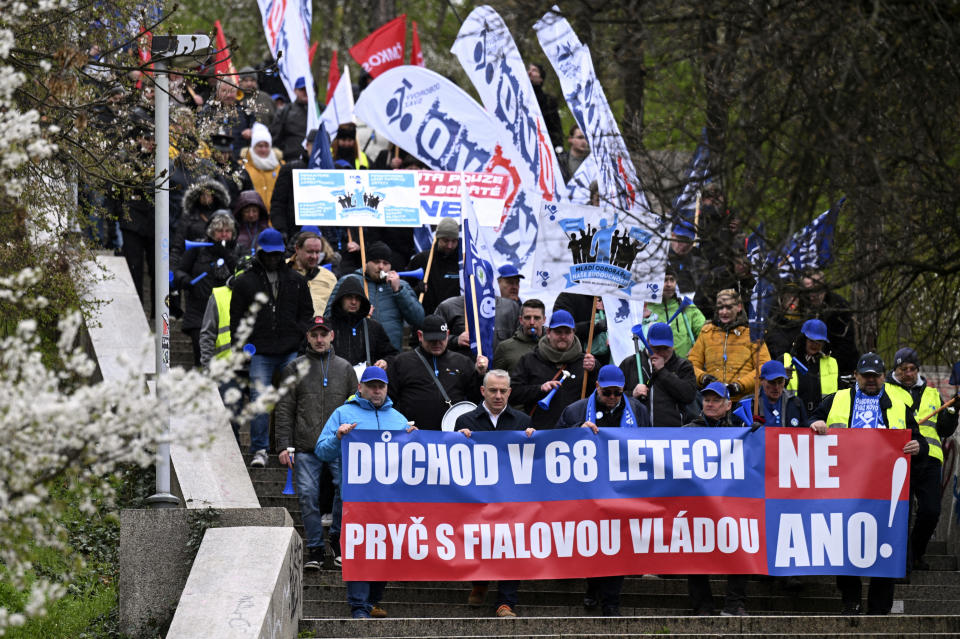 Protesters march during a demonstration of the KOVO trade union against the changes in the pension system considered by the government, in Prague, Czech Republic, Wednesday March 29, 2023. (Michal Kamaryt/CTK via AP)