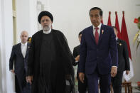 Iran's President Ebrahim Raisi, left, walks with Indonesian President Joko Widodo, right, at the Presidential Palace in Bogor, West Java, Indonesia, Tuesday, May 23, 2023. (AP Photo/Achmad Ibrahim)