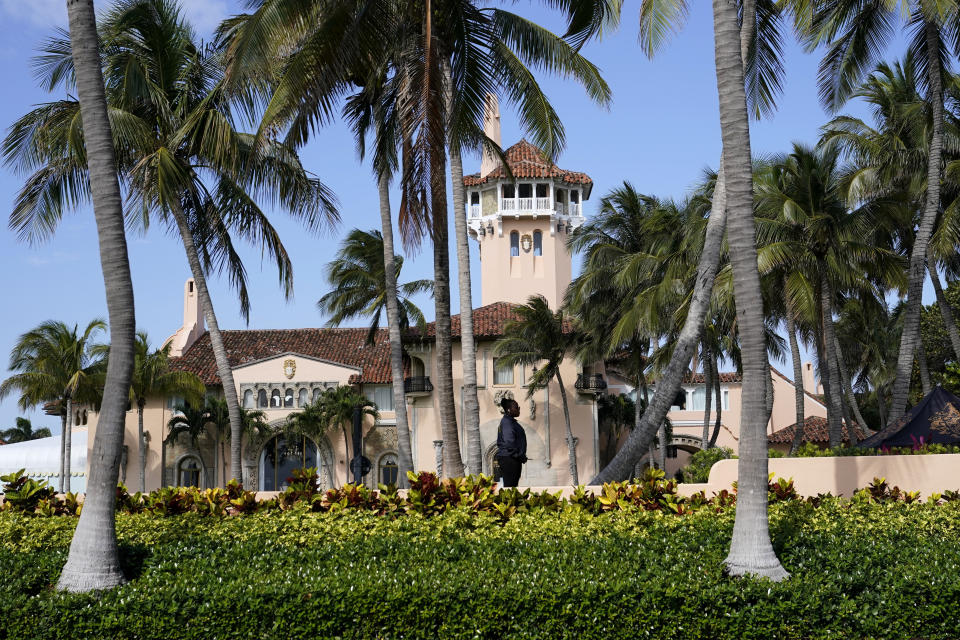 A security guard stands on the property of former President Donald Trump's Mar-a-Lago estate, Monday, March 20, 2023, in Palm Beach, Fla. (AP Photo/Lynne Sladky)