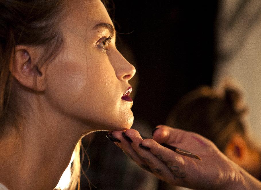 A model is readied backstage for The Nicole Miller Spring 2014 collection show during Fashion Week, Friday, Sept. 6, 2013, in New York. (AP Photo/CX Matiash)