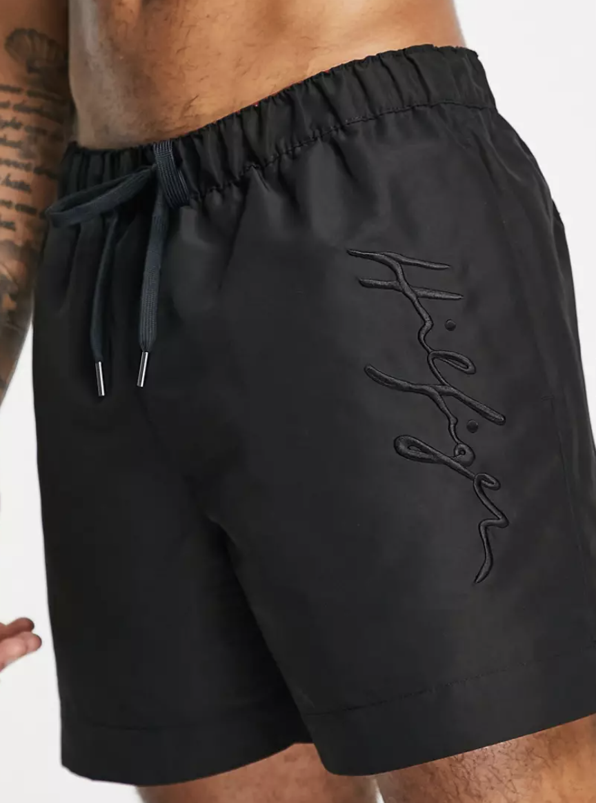 Tommy Hilfiger swim shorts with side script logo in black, $120.99 (Photo: ASOS)