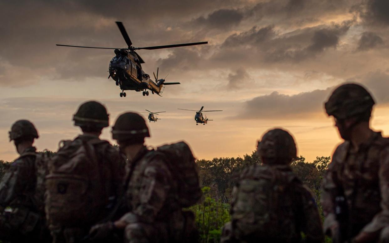 Image of soldiers from the Parachute regiment take up a position before mounting onto Puma helicopters - Corporal Ben Beale 