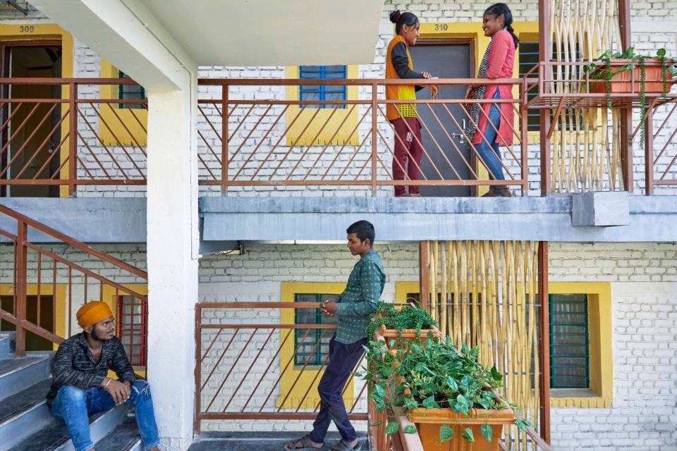 Sanjaynagar residents mingle on the stairway of a CDA-designed affordable housing unit.