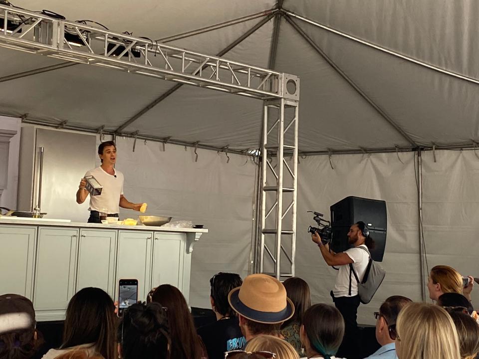 Antoni Porowski from "Queer Eye" cooks latkes and answers fans' questions during his cooking demonstration at the festival.