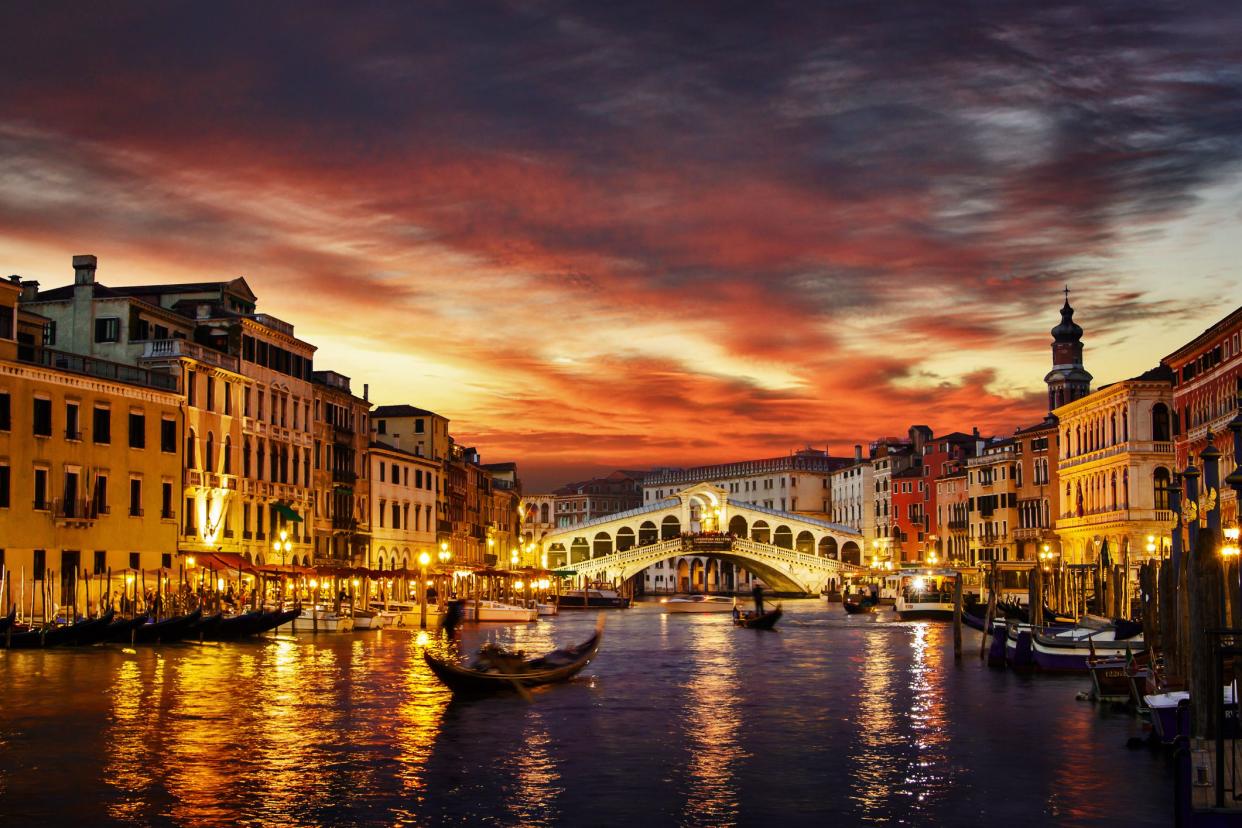 Ponte Rialto and gondola at sunset in Venice, Italy