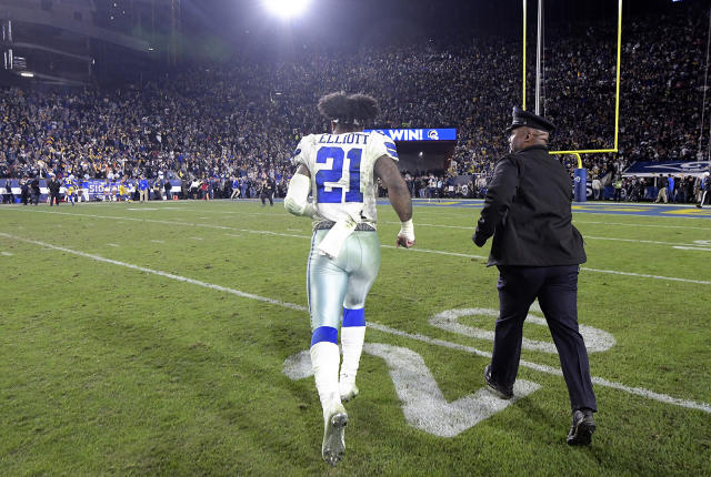 Dallas Cowboys running back Ezekiel Elliott (21) stands on the sideline  during the Pro Football Hall of Fame NFL preseason game against the  Pittsburgh Steelers, Thursday, Aug. 5, 2021, in Canton, Ohio.