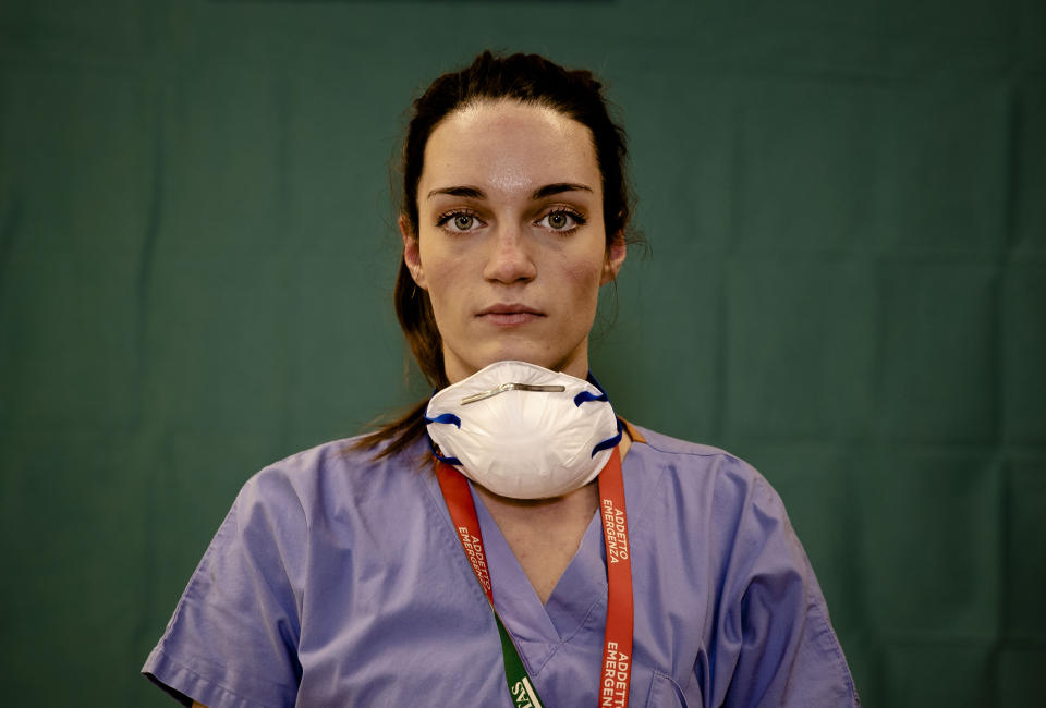 Martina Papponetti, 25, a nurse at the Humanitas Gavazzeni Hospital in Bergamo, Italy poses for a portrait at the end of her shift, March 27, 2020. (AP Photo/Antonio Calanni)