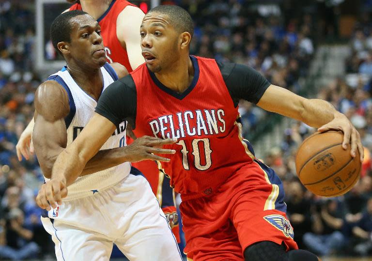 The New Orleans Pelicans' Eric Gordon dribbles past Dallas Mavericks' Rajon Rondo during their game at American Airlines Center on March 2, 2015