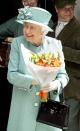 <p>Queen Elizabeth received a bouquet of flowers after visiting a replica of a Sainsbury's store in Covent Garden </p>