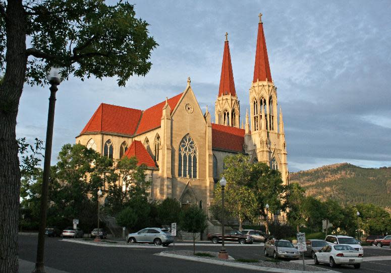 This 2011 photo shows the Cathedral of St. Helena in Helena, Mont., on a hill facing Mount Helena, a city park with hiking trails. The cathedral and park are among a number of area attractions for visitors coming to Helena for an annual festival called the Western Rendezvous of Art. (AP Photo/Ron Zellar)