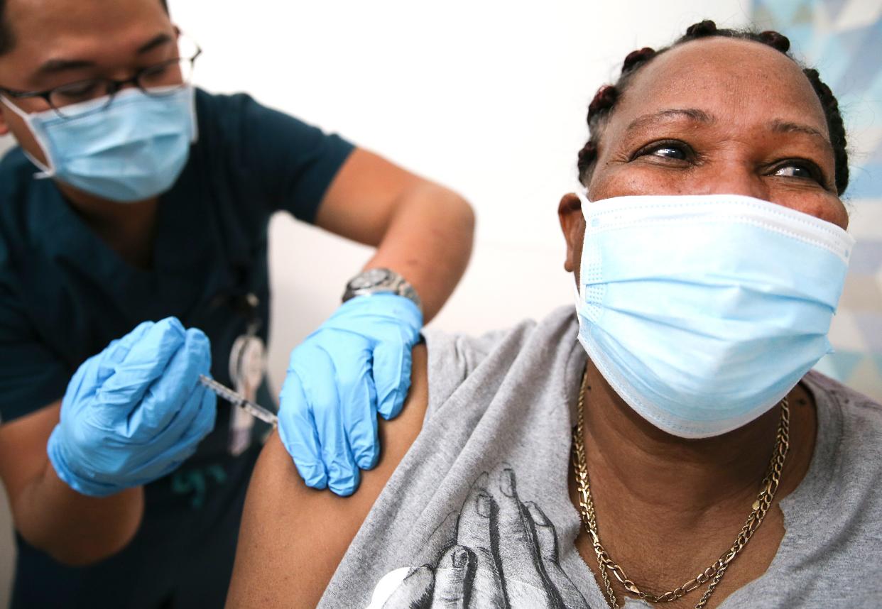 Lorraine Harvey, an in-home care worker, receives her first dose of the COVID-19 vaccine from registered nurse Rudolfo Garcia in South Los Angeles on Feb. 25, 2021 in Los Angeles.  (Photo: Mario Tama via Getty Images)