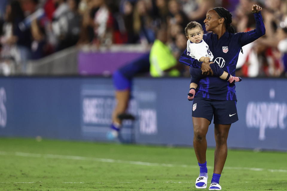 ORLANDO, FL - FEBRUARY 16: Crystal Dunn of United States of America with her son Marcel Soubrier during the 2023 SheBelieves Cup match between Canada and United States at Exploria Stadium on February 16, 2023 in Orlando, Florida. (Photo by James Williamson - AMA/Getty Images)
