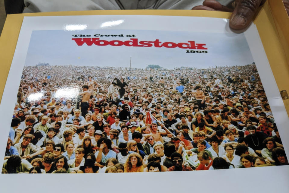 Akinyele Sadiq discusses photos taken of the crowd near the stage of the Woodstock festival in August 1969, May 9, 2023, in San Francisco, before being interviewed by the curators for the Museum at Bethel Woods as part of an effort to collect oral histories from people who were there. (AP Photo/Michael Liedtke)